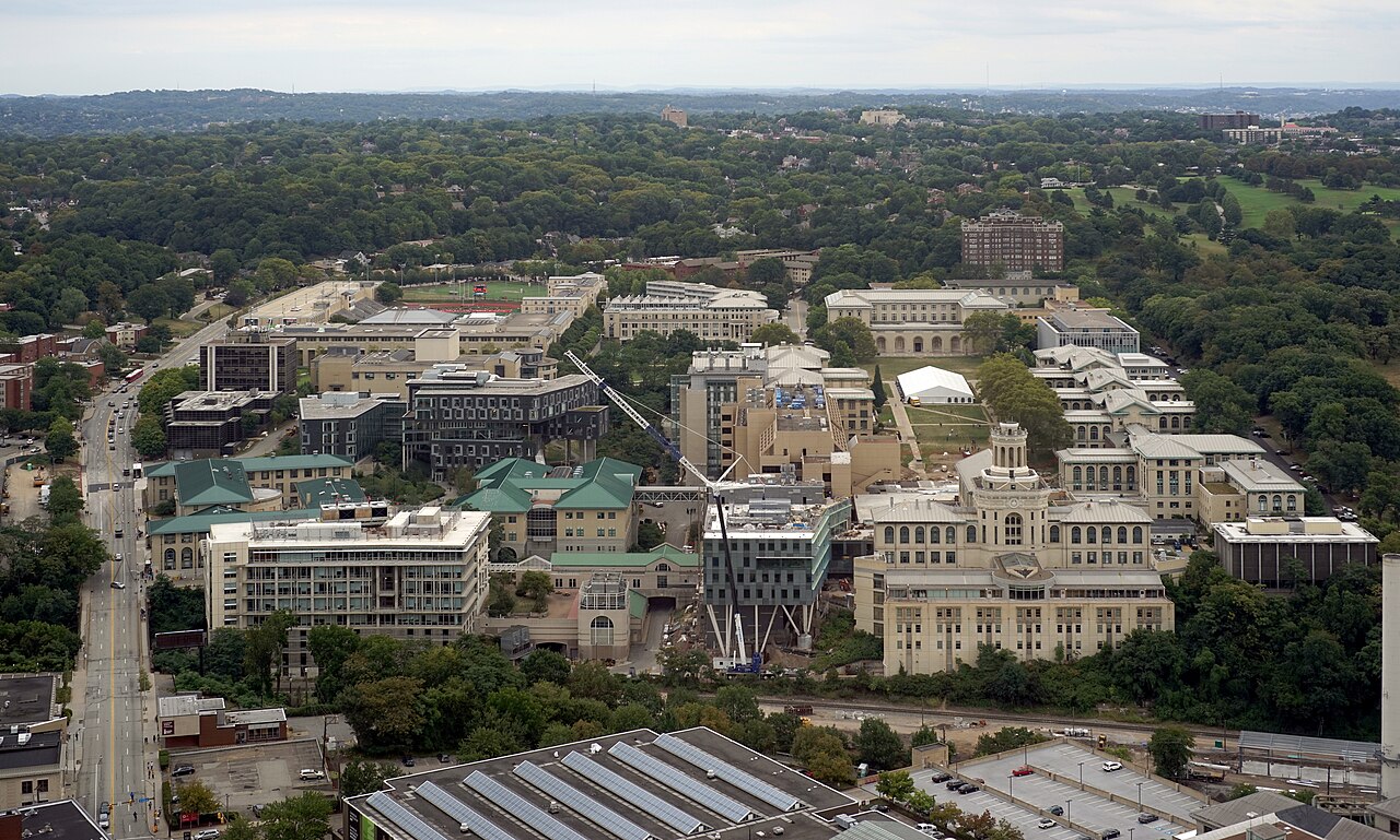 Carnegie Mellon University's Pittsburgh campus, with academic buildings surrounded by green hills.